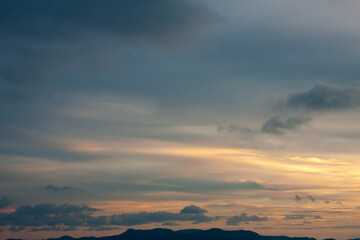 Cinematic romantic warm sky with sunset pastel clouds illuminated by last sun rays before sunset