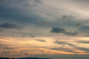 Cinematic romantic warm sky with sunset pastel clouds illuminated by last sun rays before sunset