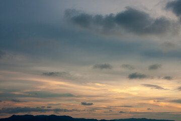 Naklejka na ściany i meble Cinematic romantic warm sky with sunset pastel clouds illuminated by last sun rays before sunset