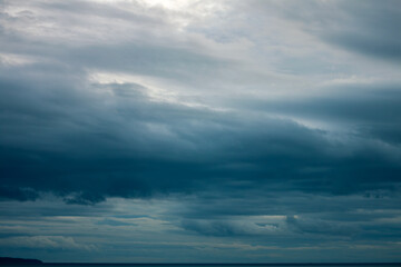 Stormy heavy mystical sky with dark rainy gloomy dramatic clouds surrounded by cinematic atmosphere