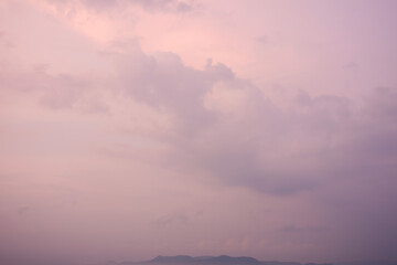 Romantic and dramatic purple sky in the morning with foggy fluffy and fantastic clouds surrounded...