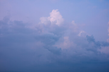 Romantic and dramatic purple sky in the morning with foggy fluffy and fantastic clouds surrounded by a hazy atmosphere