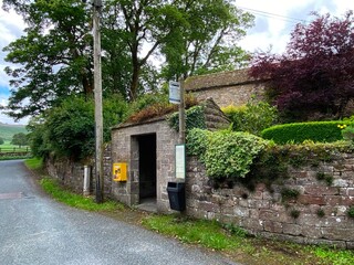 Stone bus shelter, on Raikes Lane, in the Yorkshire Dales village of, Rylstone, UK