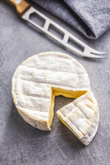 Brie type cheese with white mold. French camembert cheese on kitchen table.