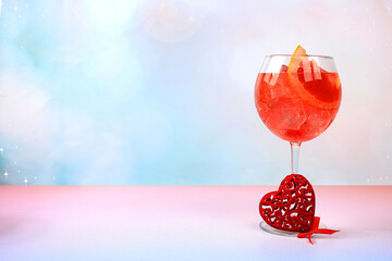 Festive alcoholic cocktail Aperol spritz in glasses and love hearts, Valentine's Day concept, alcoholic drinks at party, bar and restaurant advertising,