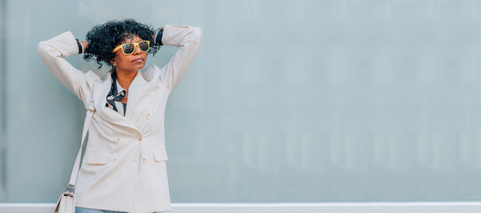 woman on the street relaxed leaning on the wall