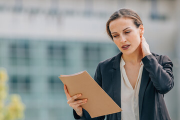 business woman or executive with documents on the street outdoors