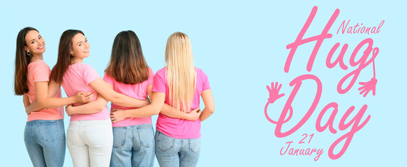 Portrait of hugging young women on blue background. National Hugging Day