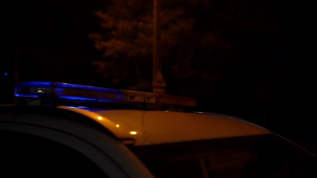 Police car with emergency lights in action.. The police arrived at the scene of the crime. The police blocked the road with a service car.