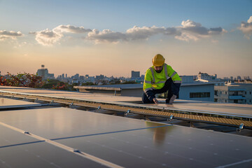 Engineer service check installation solar cell on the roof of factory. Engineers walking on roof inspect and check solar cell panel. Engineer working inspection installation solar cell on the roof