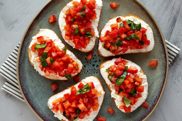 Homemade Tomato Ricotta Tartine on a Plate, top view. Flat lay, overhead, from above.