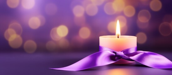 Purple ribbon for cancer awareness campaign with burning candle