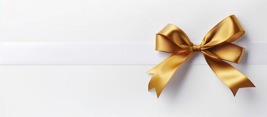 Blank white gift voucher with gold ribbon isolated on white