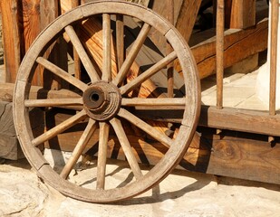 Fototapeta na wymiar Old wooden hand-wrought cart wheel.