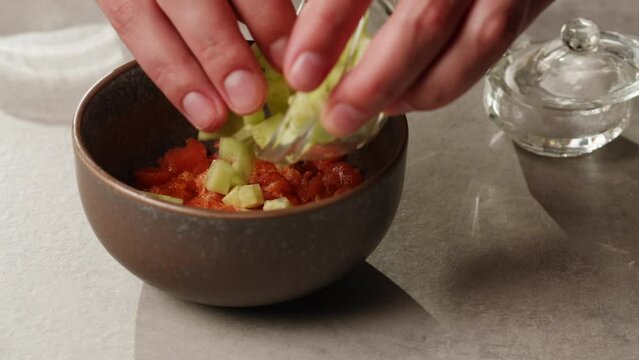 Chilean salmon tartar seviche adding fresh avocado and cucumber, onion Healthy diet food, close up red fish tar tar.