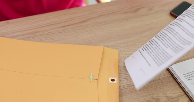 Woman secretary or manager opens envelope signing contract in business
