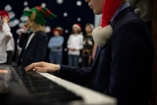 Christmas Musican Performance Of Children In School With Keyboard. Kids Play And Dance On A Stage With Music. Concert Of People.