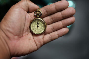 Happy 2024 concept, clock in hand