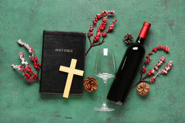 Holy Bible with cross, wine bottle and decor on green grunge background. Concept of Christmas story