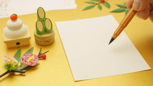 日本の年賀状イメージ(ゴールド背景)｜年賀状・筆ペン・門松・鏡餅