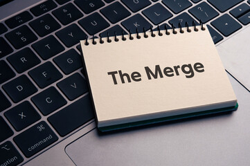 There is notebook with the word The Merge. It is as an eye-catching image.