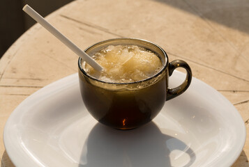 Ice beer. Creative drink. A glass mug with beer and a straw.