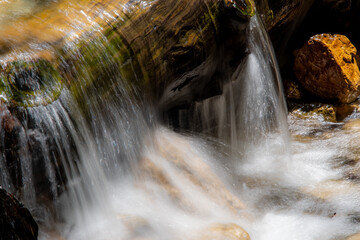 Photo of a streaming river waterfall shot in high exposure.