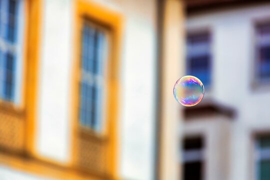 Single soap bubble floating in the city centre, Bielefeld, Germany, Europe