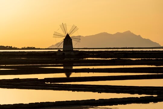 Windmill at sunset, Riserva Naturale Isole dello Stagnone di Marsala, Marsala salt flats, Trapani province, Sicily, Italy, Europe