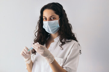 nurse portrait with mask injecting serum into a syringe