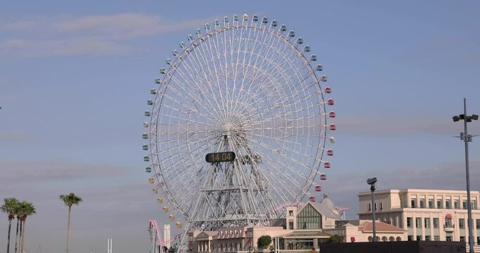 A rotating ferris wheel at the urban city in Yokohama