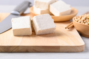 Fresh tofu on cutting wooden board, Vegan food ingredient in Asian cuisine, Plant based diet