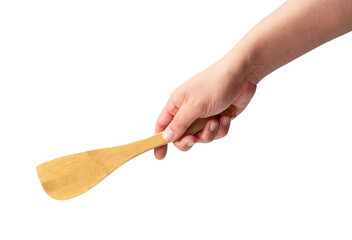 Wooden kitchen spatula in hand isolated on a white background. - obrazy, fototapety, plakaty