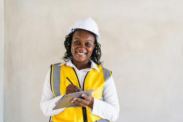 Senior professional African black female real estate foreman inspecting inside the building...