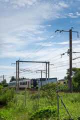 Fototapeta premium train approaching on a rural line in hokkaido japan
