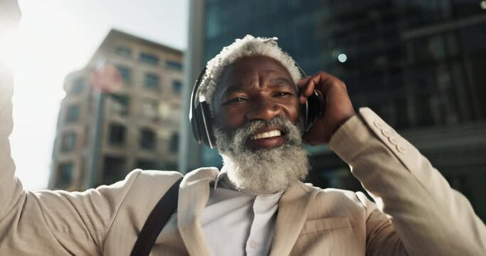 Happy, dancing and senior businessman with headphones in the city walking and listening to music. Smile, happy and elderly African male person streaming playlist, song or radio commuting in town.