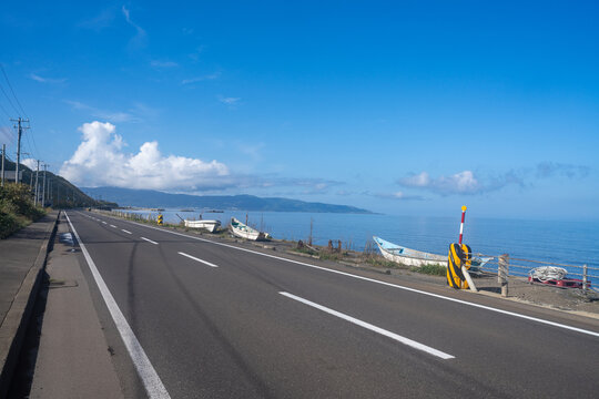 the coastline of the sea of japan from hokkaido with dry docked boats