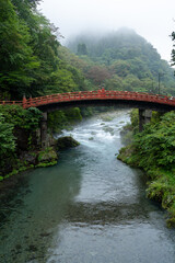 Fototapeta na wymiar shinkyo bridge across the daiya river in nikko japan on a misty day