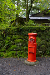 antique style post box for the japanese postal system at a temple