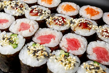 Set of sushi rolls in assortment on a black background