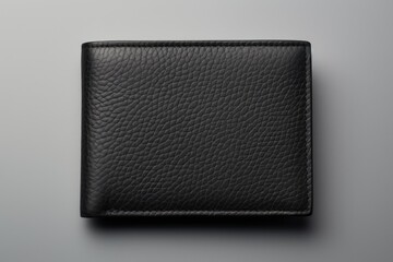 Texture-focused photograph of a black leather wallet, on a uniform light grey background. - obrazy, fototapety, plakaty