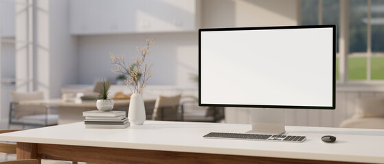 A modern luxury white home living room with a computer mockup and accessories on a white desk.