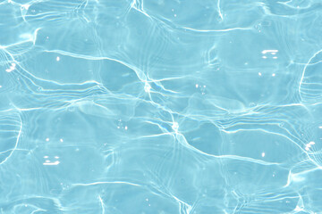  Bluewater waves on the surface ripples blurred. Defocus blurred transparent blue colored clear calm water surface texture with splash and bubbles. Water waves with shining pattern texture background. - obrazy, fototapety, plakaty