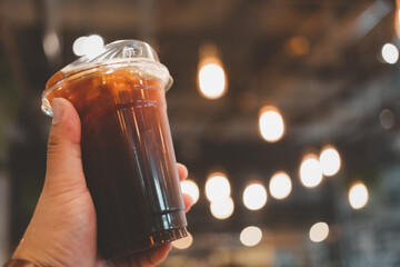 Iced black coffee or americano coffee in takeaway glass. Close up