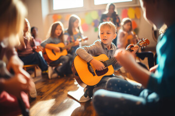 young children playing guitar in classroom - obrazy, fototapety, plakaty