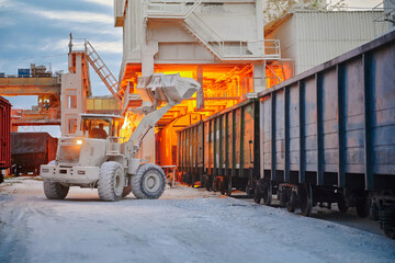 Wheel loader loads limestone into freight gondola cars