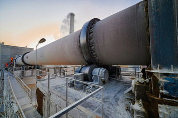 Rotating furnace for limestone roasting at plant in evening