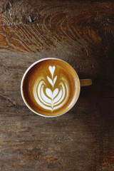 a cup of latte art coffee on wooden background                                                                                                                    