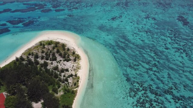 Tilt up drone shot of Managaha Island, revealing Mariana's Trench