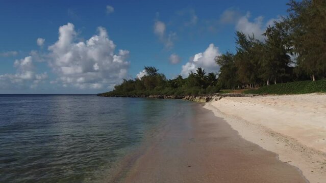 Close up and low angle drone shot of a white sand beach